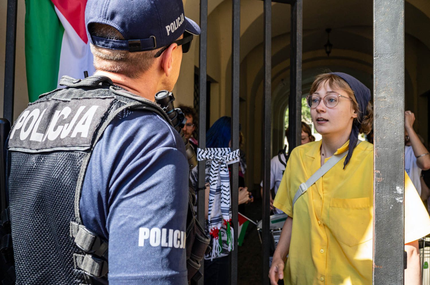 A protester speaks to police while denying them entry to the encampment during the occupation of Warsaw University in 2024.